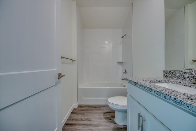 full bathroom featuring tiled shower / bath, toilet, large vanity, and hardwood / wood-style flooring