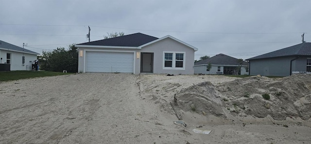 ranch-style house with stucco siding and driveway