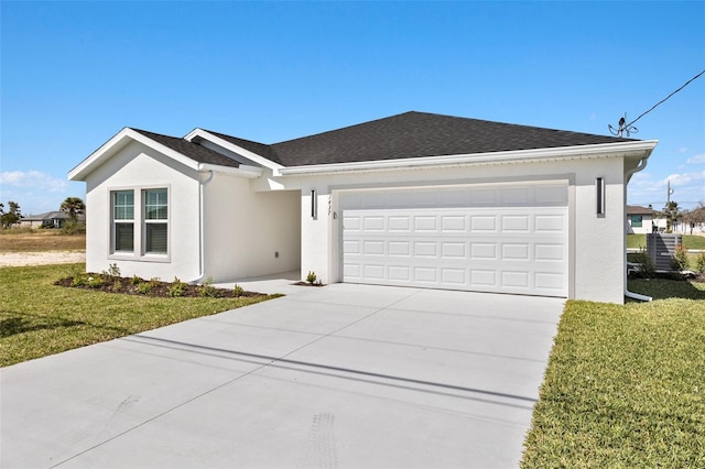 ranch-style house featuring a front yard and a garage