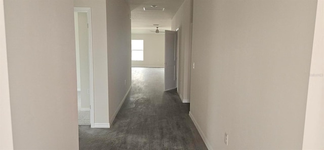 hallway featuring visible vents and baseboards