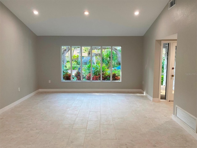 empty room featuring vaulted ceiling