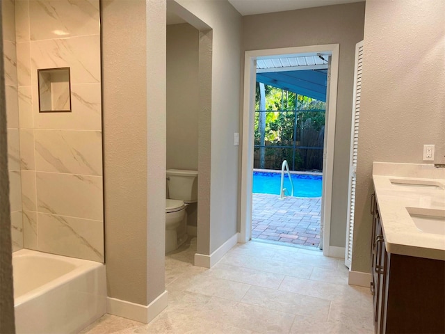 bathroom with tile patterned flooring, vanity, and toilet