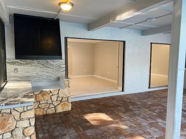 kitchen featuring beam ceiling