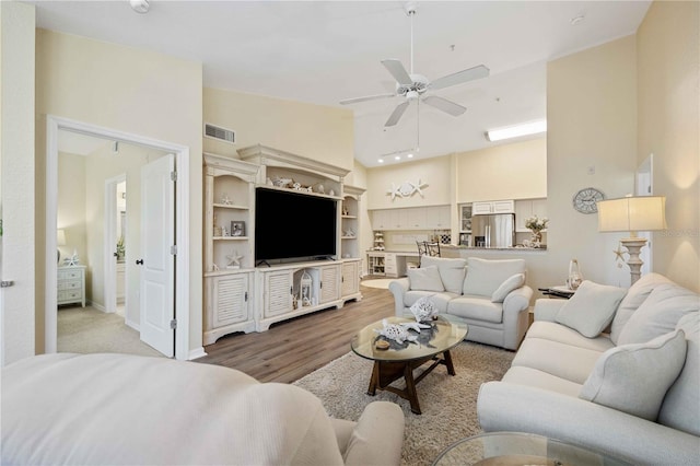 living room with ceiling fan and wood-type flooring