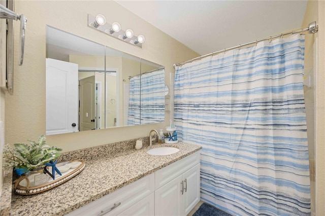 bathroom featuring vanity and curtained shower