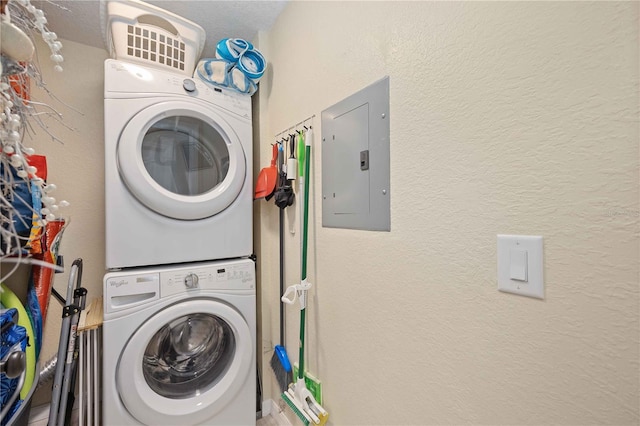 washroom with stacked washer and dryer and electric panel