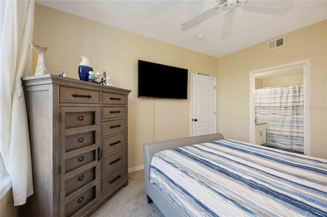 carpeted bedroom with connected bathroom and ceiling fan