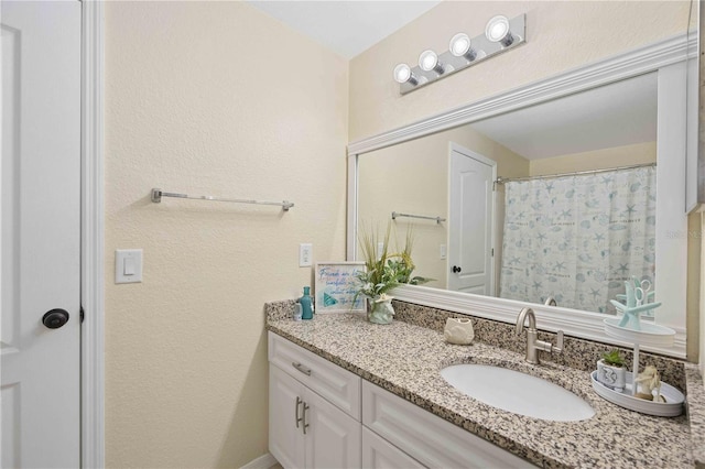 bathroom with a shower with curtain and vanity