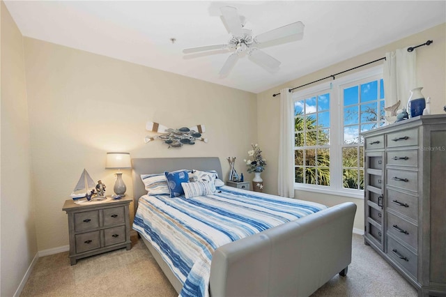 bedroom featuring light colored carpet and ceiling fan