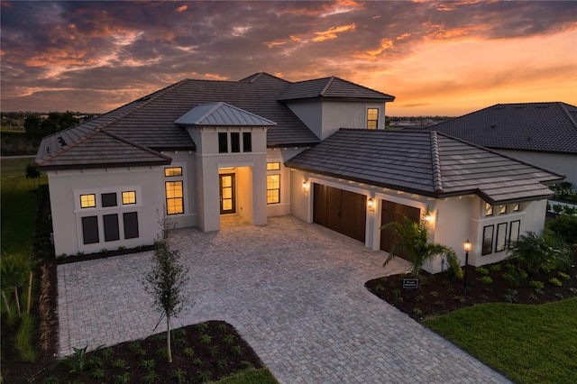 back house at dusk with a garage