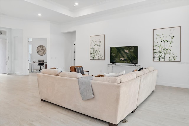 living room with ornamental molding and light hardwood / wood-style floors