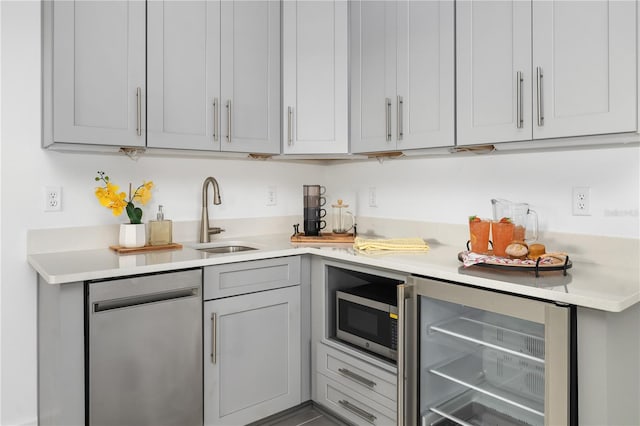 kitchen featuring gray cabinetry, stainless steel appliances, and sink