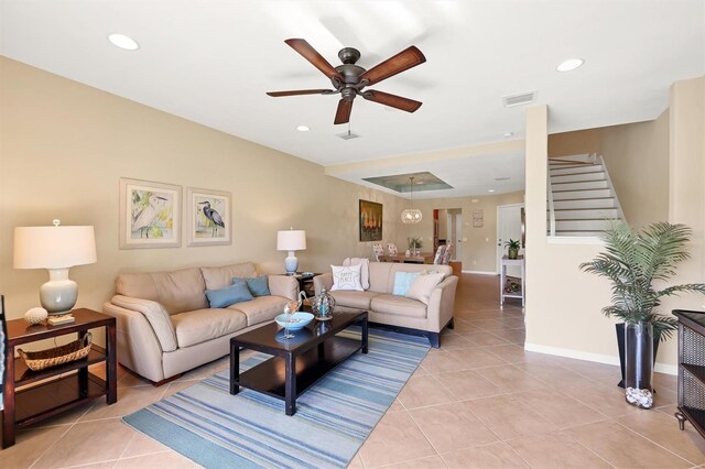 living room with light tile floors and ceiling fan