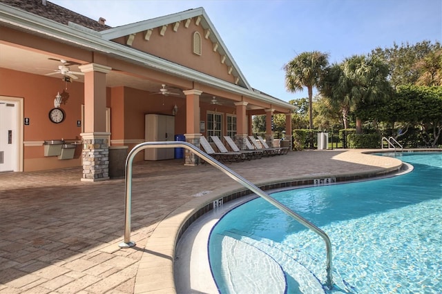 view of swimming pool with ceiling fan and a patio area