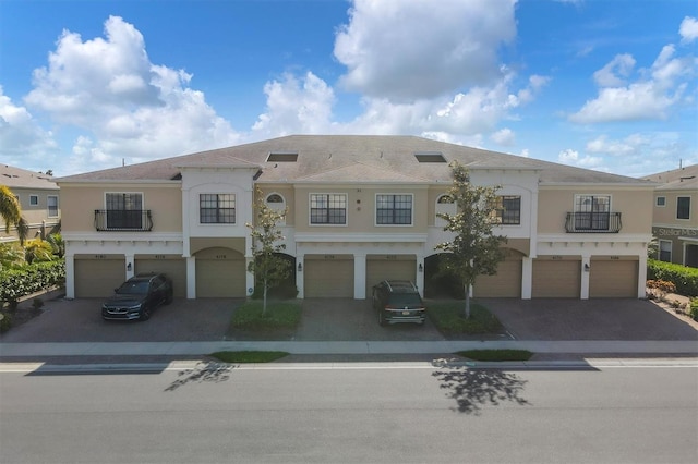 multi unit property with a balcony and a garage