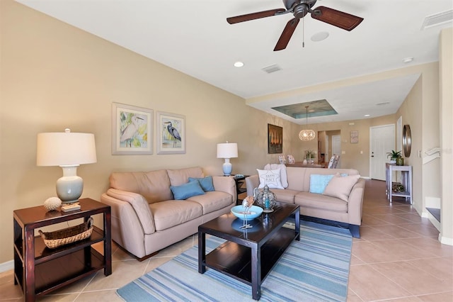 tiled living room featuring ceiling fan