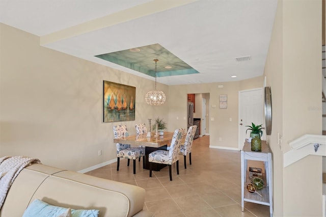 dining room with an inviting chandelier and light tile flooring