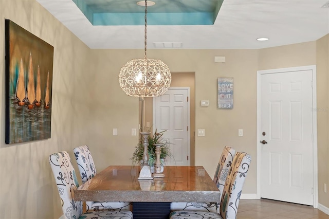 dining room featuring a chandelier and dark tile floors