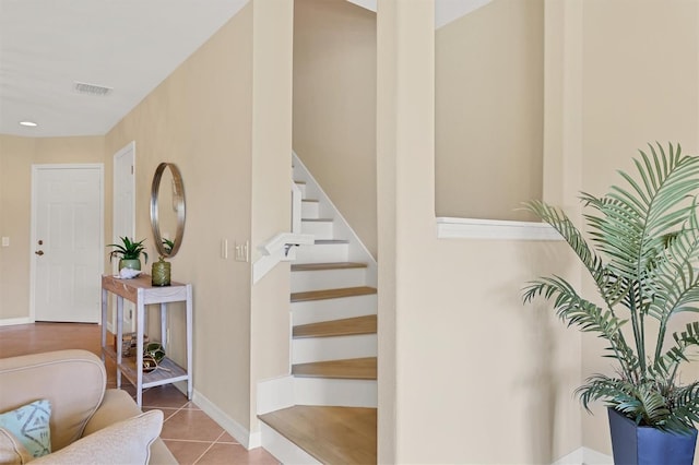 stairs featuring light tile floors