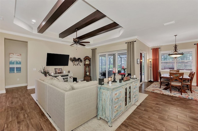 living room featuring crown molding, ceiling fan, a tray ceiling, and hardwood / wood-style flooring