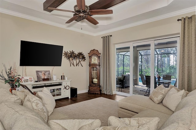 living room featuring a raised ceiling, crown molding, ceiling fan, and dark wood-type flooring