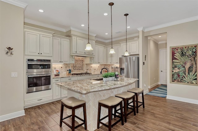 kitchen featuring hanging light fixtures, stainless steel appliances, light stone counters, tasteful backsplash, and dark hardwood / wood-style flooring