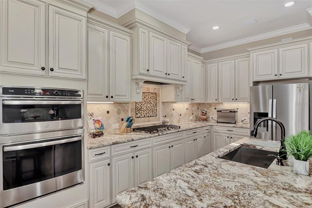 kitchen with tasteful backsplash, appliances with stainless steel finishes, and white cabinetry