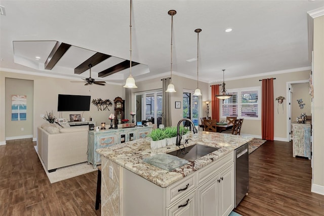 kitchen featuring hanging light fixtures, ceiling fan, sink, and beamed ceiling