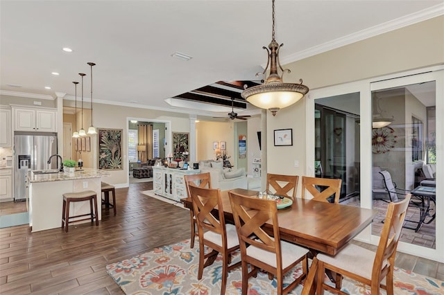 dining space featuring ornamental molding, dark hardwood / wood-style floors, and ceiling fan with notable chandelier