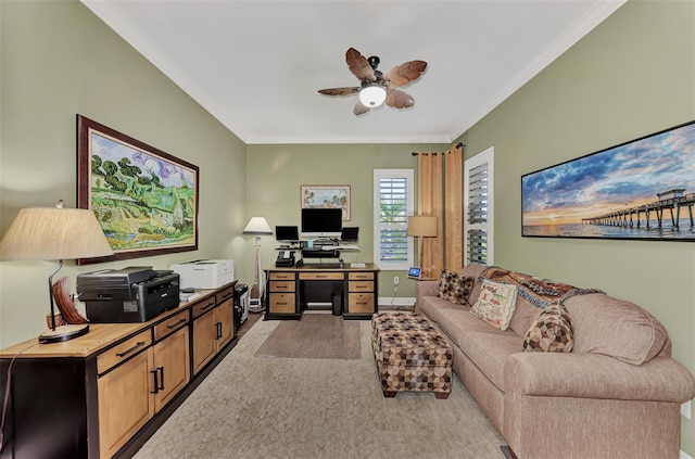 carpeted office featuring crown molding and ceiling fan