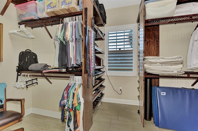 walk in closet featuring light tile floors