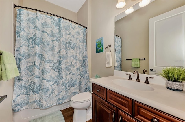 bathroom featuring hardwood / wood-style flooring, large vanity, and toilet