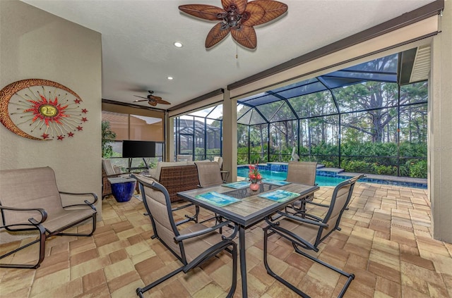 sunroom featuring ceiling fan and a wealth of natural light