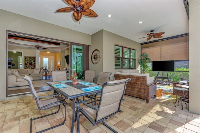 dining area featuring light tile floors and ceiling fan