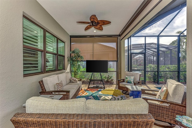 sunroom featuring ceiling fan