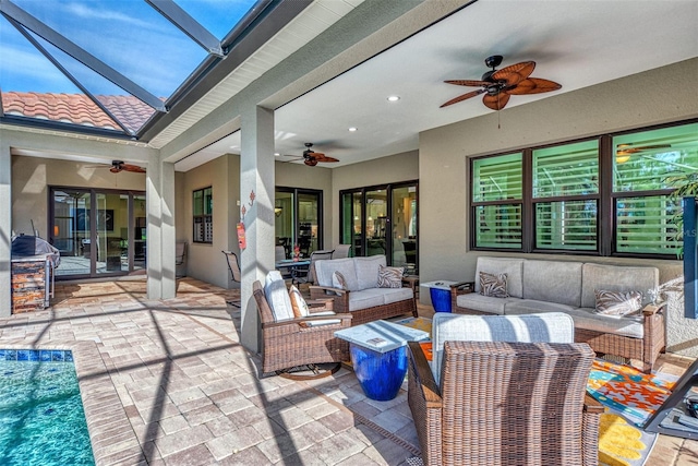 view of patio / terrace with outdoor lounge area, ceiling fan, and a lanai