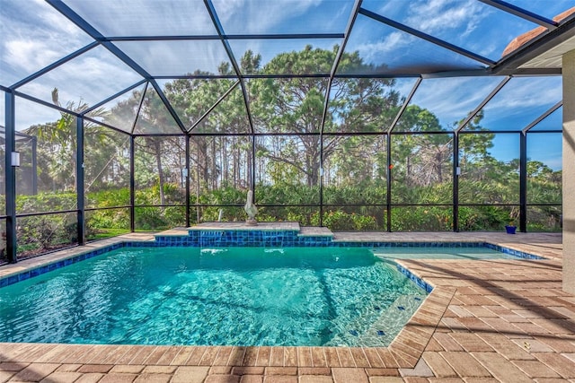 view of swimming pool with a patio area, a lanai, and pool water feature