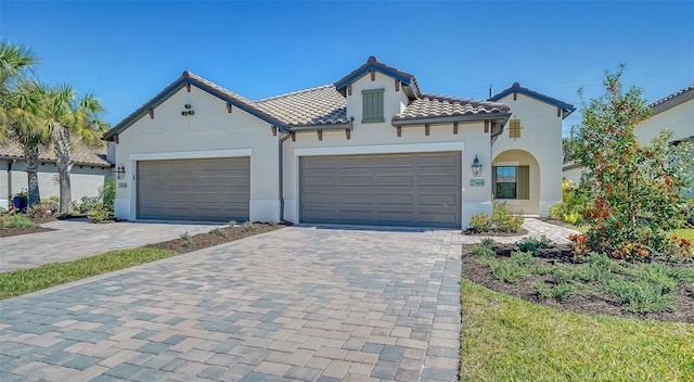 mediterranean / spanish-style house with a garage