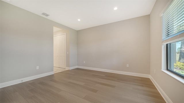 spare room featuring light hardwood / wood-style flooring