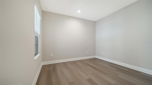 unfurnished room with hardwood / wood-style floors