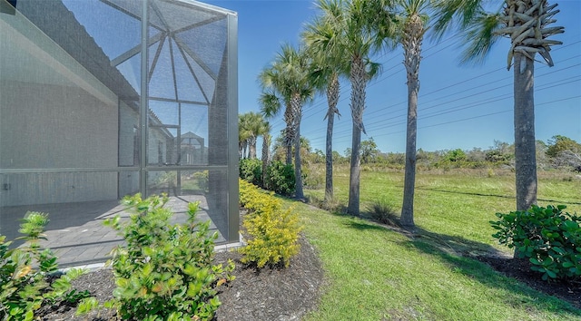 view of yard with glass enclosure