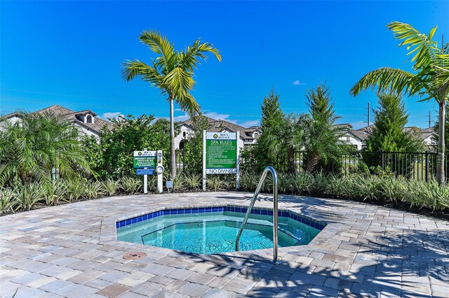 view of pool with a hot tub