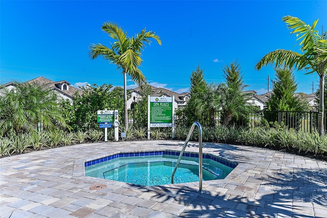 view of pool with a hot tub