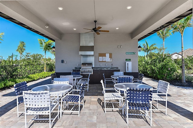 view of patio with area for grilling and ceiling fan