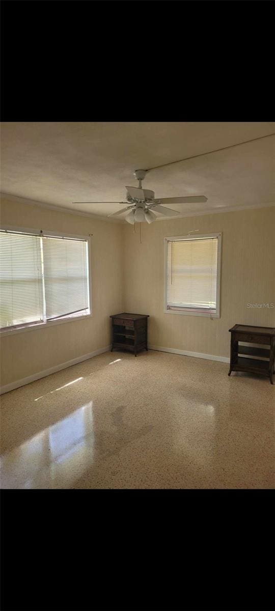 unfurnished living room with ceiling fan