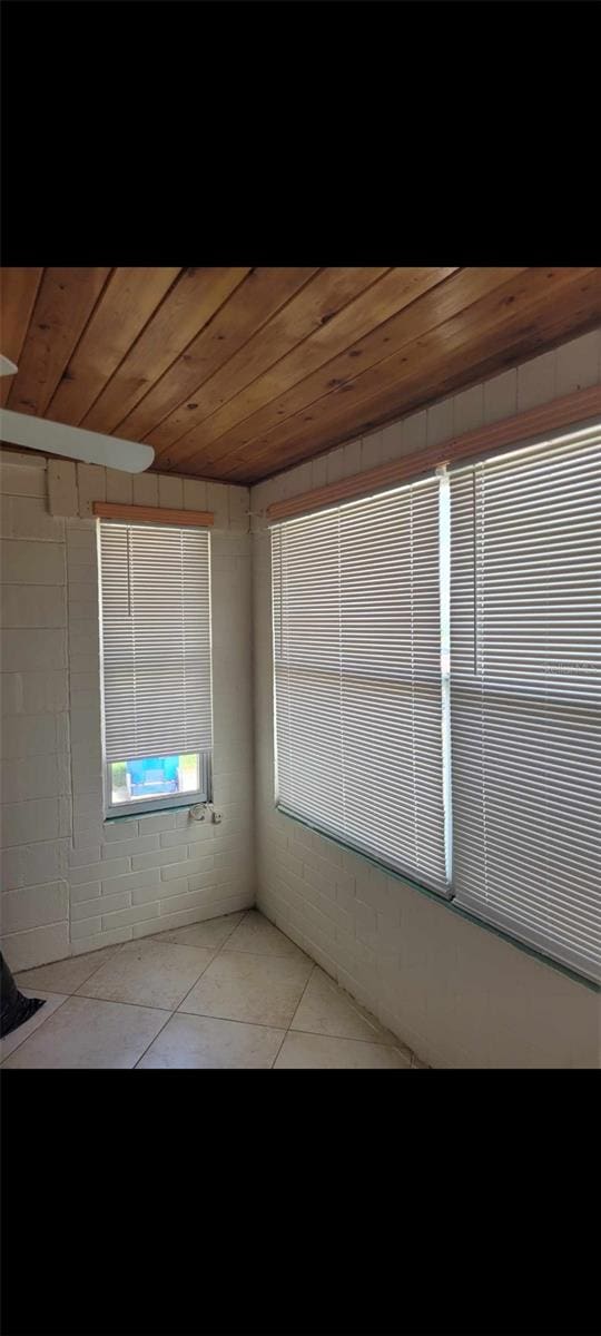 tiled spare room with wood ceiling