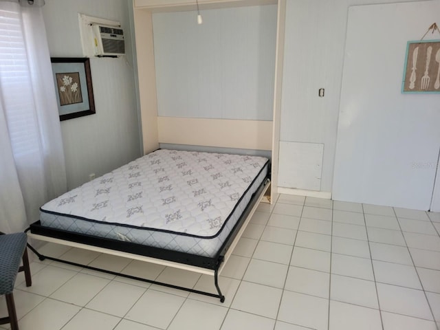 bedroom featuring a wall mounted air conditioner and light tile floors