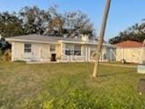 711A Pineland Ave, Venice, FL 34285 - back of property featuring a lawn