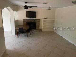 711A Pineland Ave, Venice, FL 34285 - living area featuring a brick fireplace and a ceiling fan