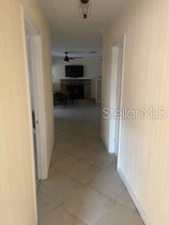 711A Pineland Ave, Venice, FL 34285 - hall featuring light tile patterned floors and baseboards